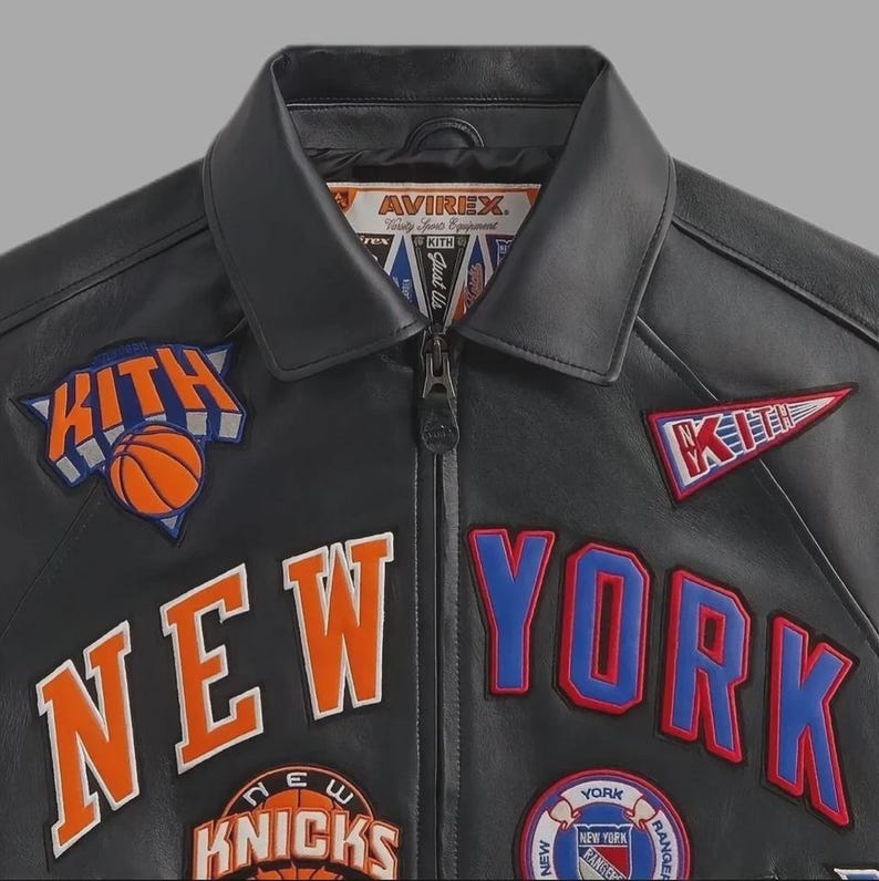 May include: Black leather jacket with "NEW YORK" and "KITH" patches in orange, blue, and white. Features a basketball graphic and the "AVIREX" logo. A stylish jacket for sports fans.