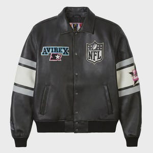 May include: Black leather jacket with white and gray stripes on the sleeves. Features the "AVIREX" and "NFL" logos. The jacket has a button-up front, a collar, and a ribbed hem and cuffs. A stylish piece of outerwear.