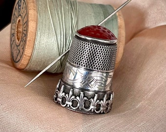 Sterling Silver thimble, antique sewing, finely decorated with fleur de lis, carnelian glass top.