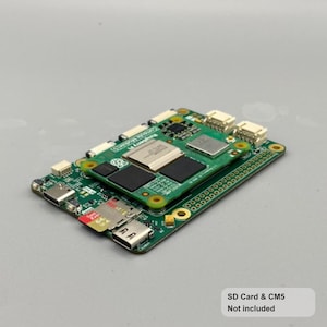 May include: A green circuit board with various electronic components, including chips, connectors, and a micro SD card slot. The board is rectangular and has a smaller board stacked on top. The text "SD Card & CM5 Not included" is visible.