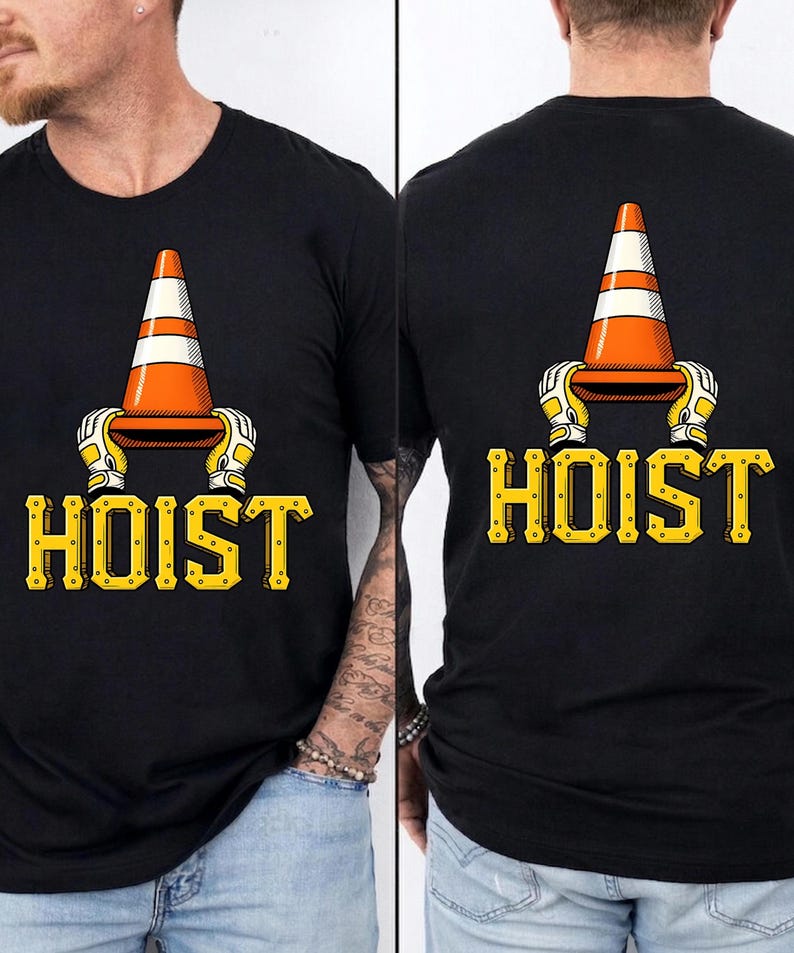 May include: Black t-shirt featuring a graphic of an orange and white traffic cone held by yellow and white gloved hands. The word "HOIST" is printed in yellow, stylized lettering below the graphic.