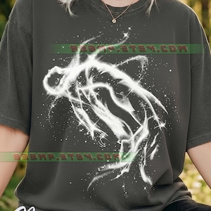 May include: Dark grey t-shirt with a white, luminous figure in a dynamic pose, set against a starry background. The word "Pepper" is at the bottom. The Etsy shop name is visible in green text.