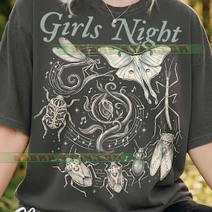 May include: A charcoal grey short-sleeve t-shirt featuring the text Girls Night in a light green font. The graphic includes a central rose surrounded by various insects such as a moth, dragonfly, beetle, and stick insect, accented with musical notes.