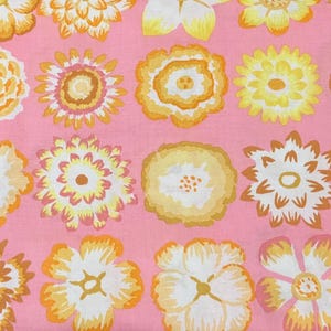 May include: Pink fabric with a repeating pattern of yellow, orange, and white flowers. The flowers are stylized and have a retro look.