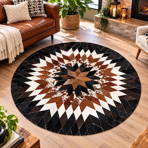 Può includere: Un tappeto circolare con un motivo geometrico a stella composto da pannelli individuali in texture di pelle bovina nera, bianca, marrone e maculata. Il design si irradia da un punto centrale, creando un motivo a stella simmetrico e multicolore.