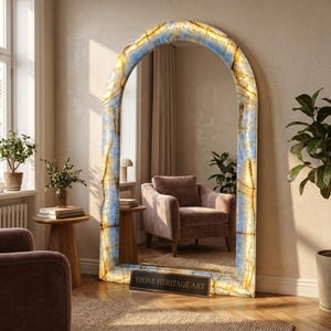 May include: An arched floor mirror featuring a translucent blue and gold onyx stone frame with internal illumination. The base of the frame displays a rectangular plaque with the text STONE HERITAGE ART in gold lettering on a dark background.
