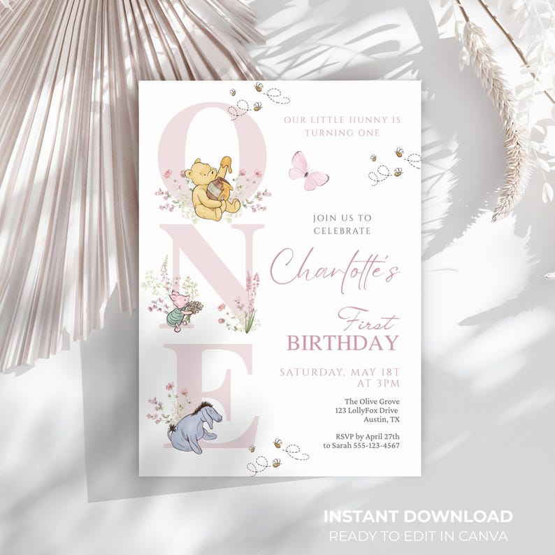 May include: A printable first birthday invitation featuring Winnie the Pooh characters. The design includes the name "Charlotte's", the date, time, and location. The invitation has a soft pink and beige color scheme with floral accents.