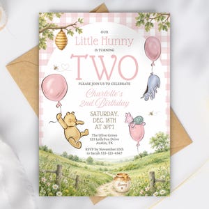 May include: A birthday invitation card featuring a pink gingham background, a honey pot, and illustrations of a yellow bear, a pink pig, and a grey donkey holding balloons. The text reads: Our Little Hunny is turning TWO, Charlotte's 2nd Birthday.