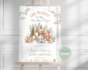 May include: A baby shower sign on an easel with a woodland theme. The sign features watercolor illustrations of forest animals, including a bear, fox, and raccoon. Text reads "Oh Baby! Let the Adventure Begin" and "Welcome to Jessica Miller's Baby Shower."