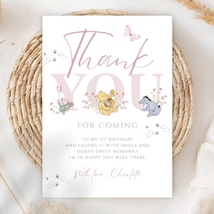 May include: A white card with the words "Thank You" in pink script and block letters. Winnie the Pooh characters are featured. The card reads "For coming to my 1st birthday..." and is signed "With love, Charlotte."