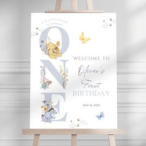 May include: A white ceramic mug with a black handle and the text "But First, Coffee" in a bold, black font. The mug is set against a neutral background, highlighting its simple design.