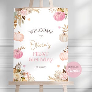May include: A white sign on an easel, featuring a floral and pumpkin design. The sign reads "Welcome to Olivia's First Birthday" in gold and pink lettering, with the date 28.10.2026. Decorated with watercolor pumpkins and flowers, it's a birthday party sign.