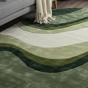 May include: A round rug with a wavy design in shades of green and white. The rug features a soft, textured surface and a pattern that resembles rolling hills or waves. The color palette includes light, medium, and dark green tones.
