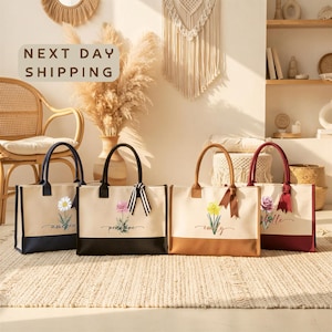 four handbags with floral designs, arranged on a beige rug in a room with a woven chair and a wall with a hanging plant.