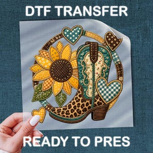 May include: A DTF TRANSFER READY TO PRESS graphic featuring a sunflower and a cowboy boot with a leopard print base and a quilted pattern. The design is accented with teal and brown hearts arranged in a circular composition with yellow and green tones.