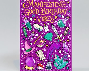 May include: A purple greeting card with the text "MANIFESTING GOOD BIRTHDAY VIBES" in yellow. The design features illustrations of potion bottles, a sword, a crystal ball, a quill in an inkwell, crystals, a witch hat, a frog, and a candle.