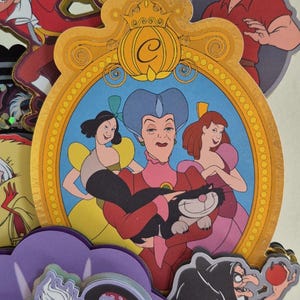 May include: A collection of colorful cartoon character cutouts, including villains and princesses. The central image features a portrait of Cinderella's stepmother and stepsisters. Other characters include Ursula, Captain Hook, and Gaston.