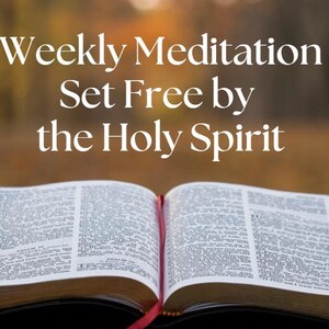 May include: An open book with text, featuring the words "Weekly Meditation Set Free by the Holy Spirit" in white. The book has a red ribbon bookmark. The background is a blurred view of autumn foliage.