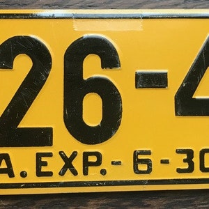 May include: A yellow metal license plate with black numbers and text. The numbers are "326-41" and the text is "W. VA. EXP. 6-30-53".