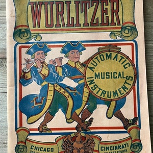 May include: Vintage Wurlitzer advertisement featuring two cartoon figures in blue and yellow uniforms, one playing a flute and the other carrying a drum that reads "Automatic Musical Instruments." The ad includes the text "Chicago 268 Wabash Ave" and "Cincinnati 121 East Fourth."