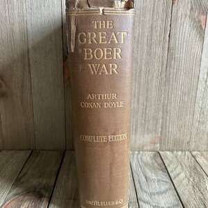 May include: A vintage book titled "The Great Boer War" by Arthur Conan Doyle. The book is a complete edition and published by Smith, Elder & Co.