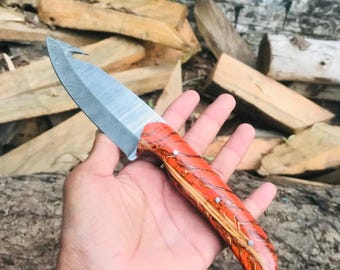 Cuchillo de desollar de acero de Damasco, hecho a mano, con mango de madera de resina y funda de cuero.