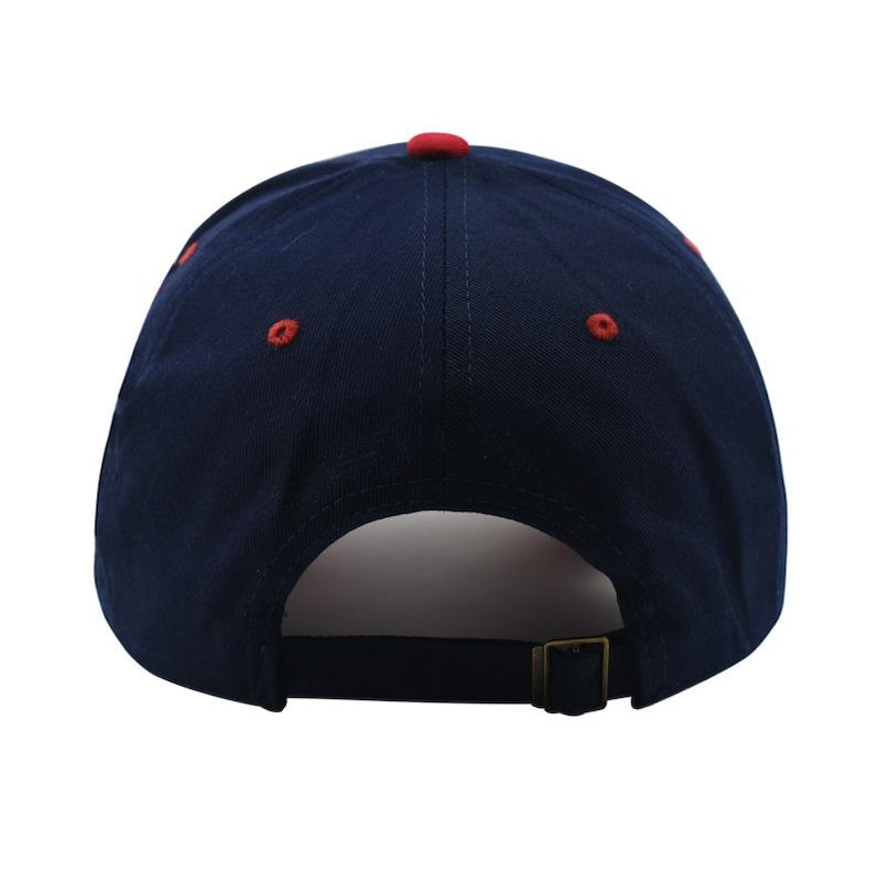 May include: A navy blue baseball cap with a red button on top and red stitching details. The cap has a curved brim and an adjustable metal buckle closure at the back. The hat is made of a durable fabric.