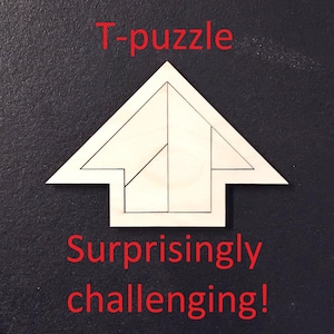 May include: A wooden T-puzzle with the text "T-puzzle" and "Surprisingly challenging!" in red. The puzzle is shaped like an arrow and is made of several interlocking pieces. The background is dark gray.