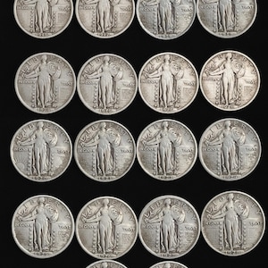 May include: A selection of silver Standing Liberty quarters, featuring the Liberty design. The coins are arranged in rows against a black backdrop, highlighting their intricate details and historical value. The dates on the coins range from 1916 to 1930.