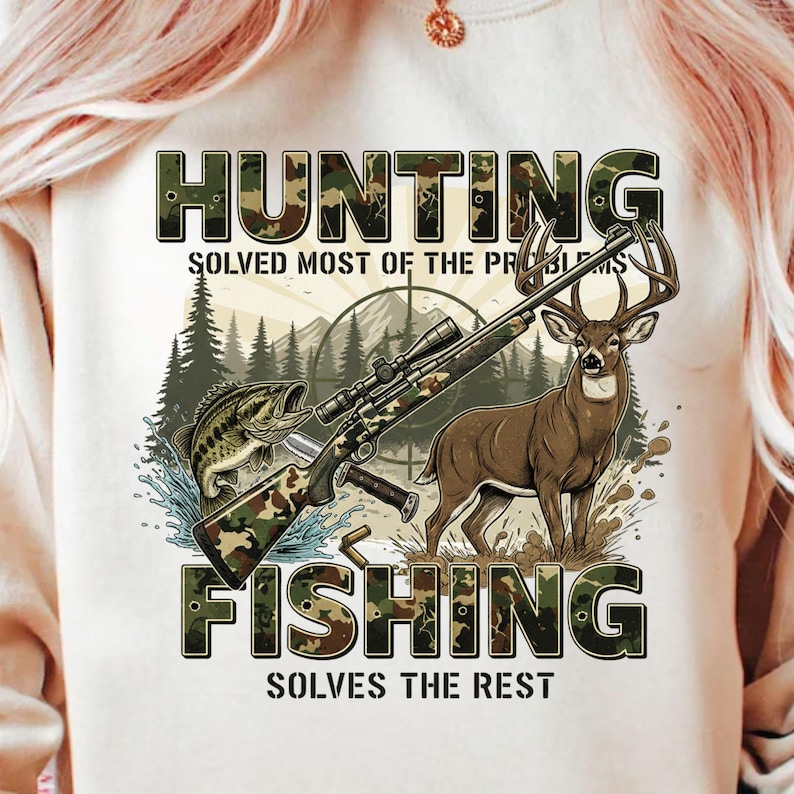May include: Cream-colored graphic tee featuring the words "HUNTING" and "FISHING" in camouflage lettering. The design includes a rifle, a deer, a fish, and the text "SOLVES MOST OF THE PROBLEMS" and "SOLVES THE REST".