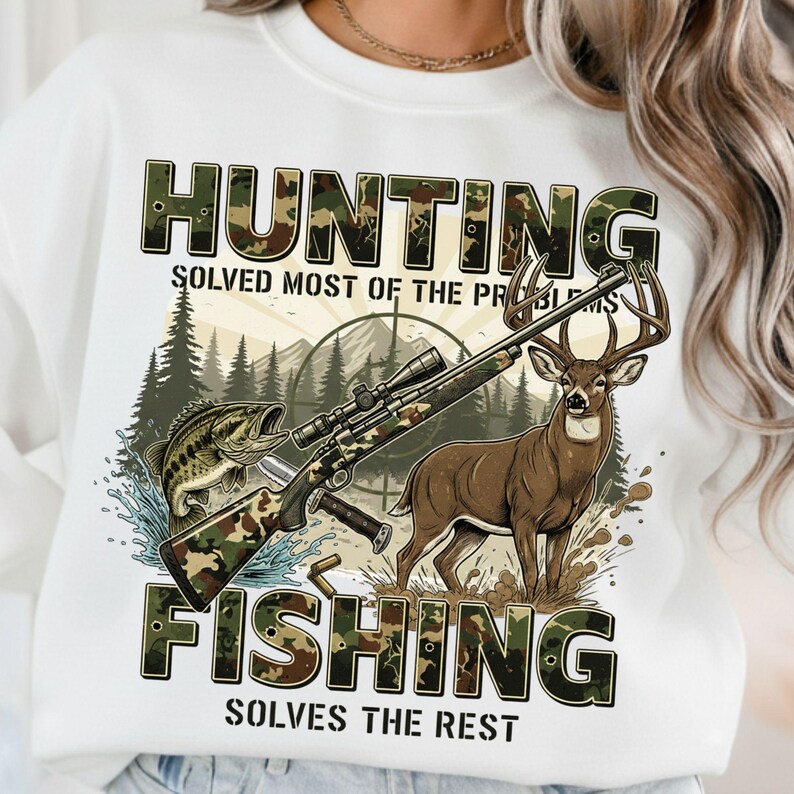 May include: White sweatshirt with a hunting and fishing graphic. The design includes a rifle, a deer, a fish, and the text "HUNTING SOLVED MOST OF THE PROBLEMS FISHING SOLVES THE REST". The text and rifle have a camouflage pattern.