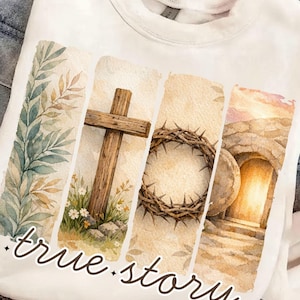 May include: White sweatshirt featuring a watercolor design with four vertical panels. The panels depict leaves, a wooden cross, a crown of thorns, and an open tomb. The words "true story" are written in cursive at the bottom.