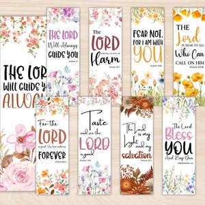 May include: A collection of floral bookmarks with inspirational quotes. Each bookmark features a unique design with watercolor flowers and uplifting messages like "The Lord Will Guide You Always" and "Fear Not, For I Am With You."