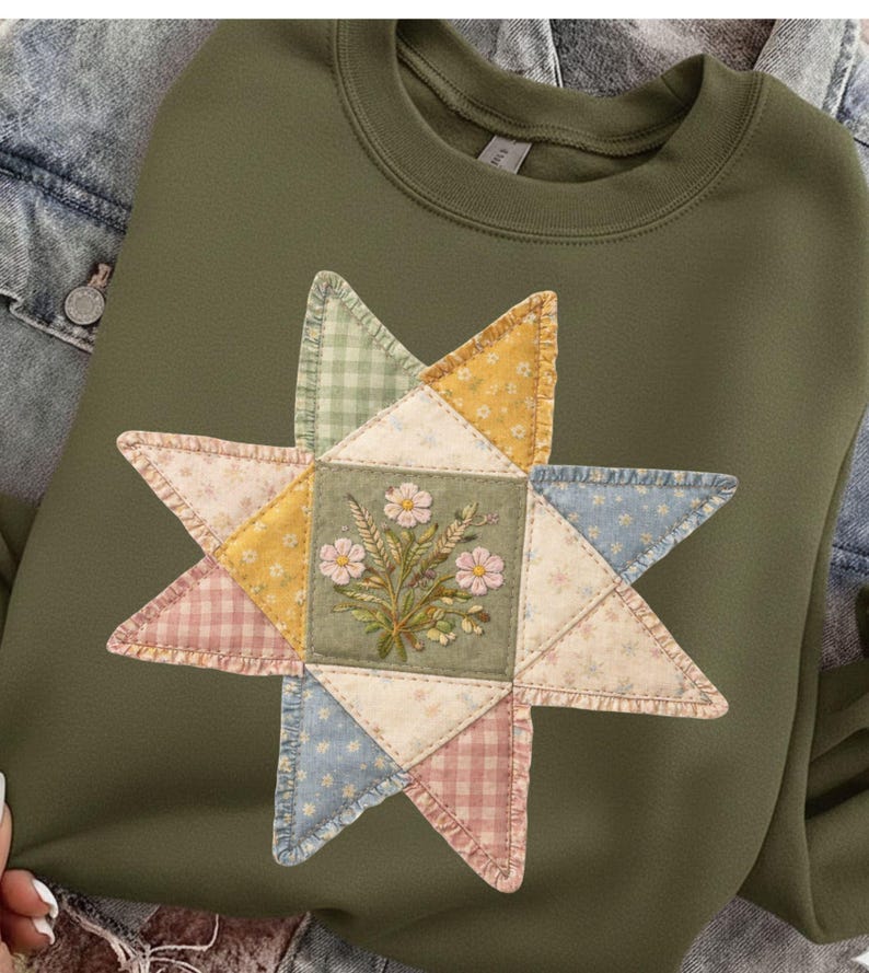 May include: Olive green sweatshirt featuring a star-shaped appliqu&eacute;. The appliqu&eacute; is made of various patterned fabrics, including floral, gingham, and dotted designs, surrounding a central square with embroidered flowers. The sweatshirt has a crew neck and long sleeves.