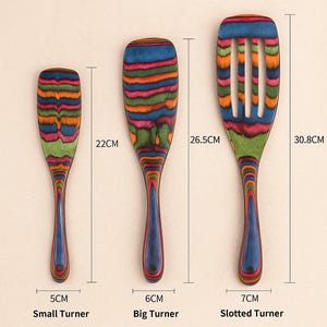 May include: Wooden kitchen utensil set with a colorful striped design. Includes a small turner (5cm), a big turner (6cm), and a slotted turner (7cm). The slotted turner is 30.8cm long.