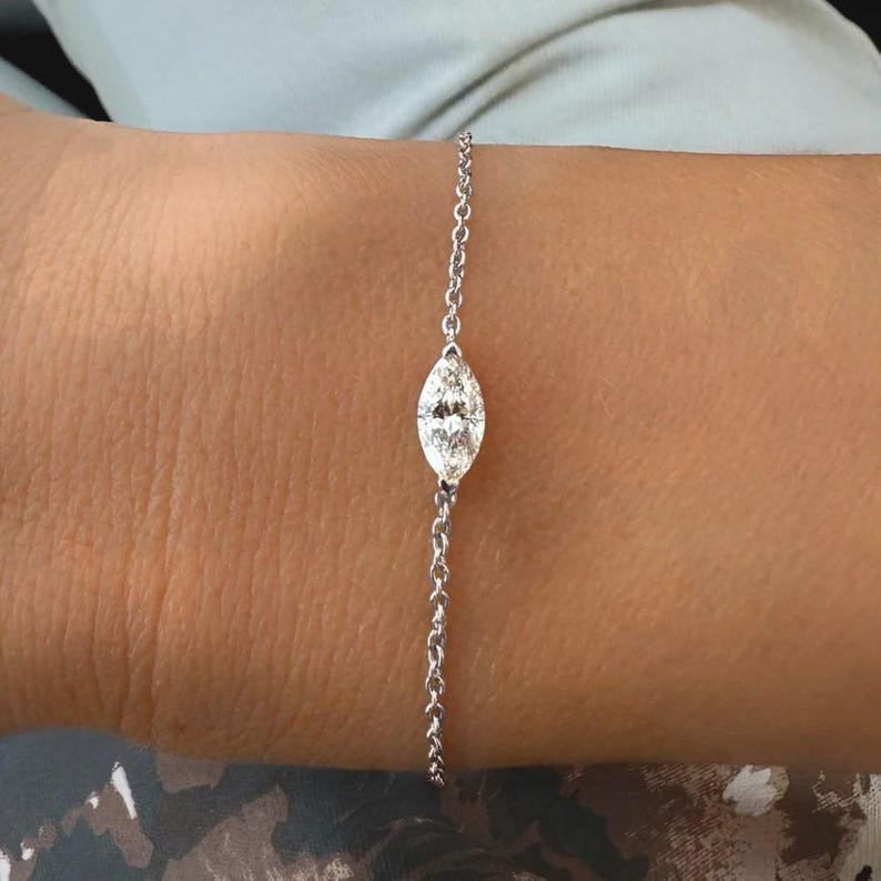 Puede incluir: Una delicada pulsera de plata con un diamante talla marquesa. El diamante es el punto focal, engastado en un dise&ntilde;o simple y elegante. La pulsera es una fina cadena, adecuada para el uso diario o ocasiones especiales.
