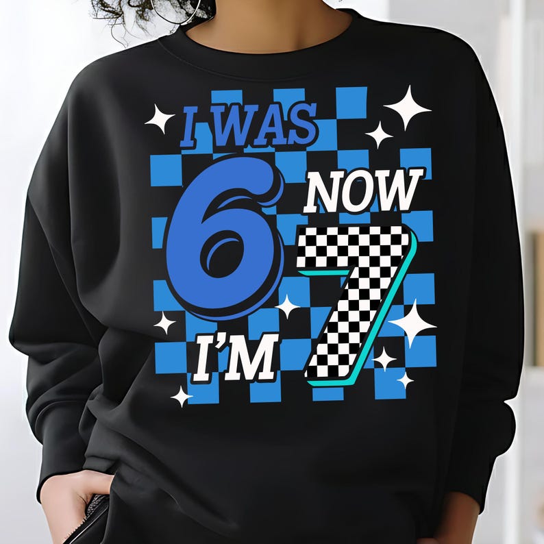 May include: Black sweatshirt with a blue and white checkered design. The graphic reads "I WAS 6 NOW I'M 7" in blue and white. White starbursts are scattered around the text. A fun birthday shirt.“i was six now i’m seven shirt” “six seven kid birthday”
