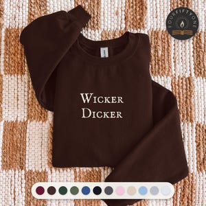 May include: A dark brown long-sleeve crewneck sweatshirt featuring the white text Wicker Dicker embroidered on the center chest. The garment includes a small circular logo in the top right corner with the text FOURFIFTYONE.