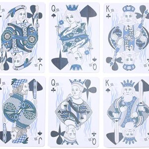 May include: Six playing cards featuring Jacks, Queens, and Kings in a blue and white color scheme. Each card displays a unique illustration of a royal figure with traditional suit symbols. The cards are arranged in two rows of three.