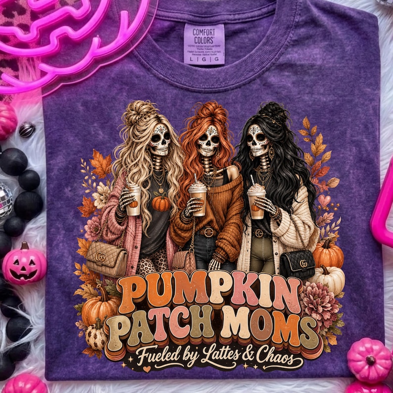 May include: Purple Comfort Colors t-shirt featuring a graphic of three skeleton women holding coffee cups, with the text "Pumpkin Patch Moms" and "Fueled by Lattes & Chaos". The design includes pumpkins and fall foliage.