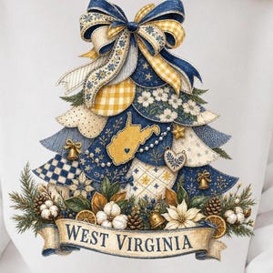 May include: A graphic print on a white garment featuring a stylized Christmas tree composed of layered fabric patterns in navy blue, cream, and yellow. The tree includes a map of West Virginia, a large bow, bells, and a banner reading WEST VIRGINIA.
