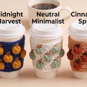 May include: Seven white paper coffee cups with crochet sleeves featuring small pumpkin motifs. The sleeves are labelled Cozy Fall Classic, Spooky Pastel, Midnight Harvest, Neutral Minimalist, Cinnamon Spice, Autumn Moss, and Harvest Gold.