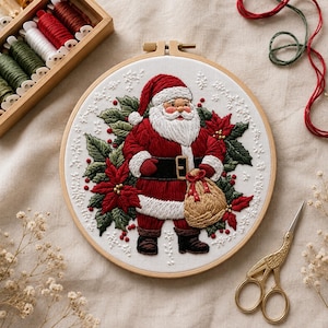 May include: A circular embroidery hoop containing a white fabric panel with a detailed thread-stitched Santa Claus figure. Santa wears a red suit with white trim, a black belt, and dark boots, holding a tan sack amidst green holly and red poinsettias.