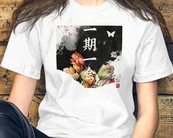 May include: White t-shirt with a square graphic featuring Japanese characters, a butterfly, and watercolour flowers in red, orange, and green. The design is set against a black background.