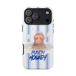 May include: A white phone case with blue vertical stripes and a cartoon monkey in a bath. The monkey has a pink face and is wearing a white hat. The words "PUNCH MONKEY" are written in blue script.