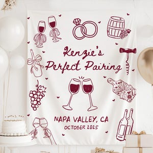 May include: A white fabric backdrop featuring dark red line art illustrations of wine glasses, a diamond ring, a wine barrel, a corkscrew, grapes, and a charcuterie board. The text reads Kenzie's Perfect Pairing, NAPA VALLEY, CA, OCTOBER 2025.