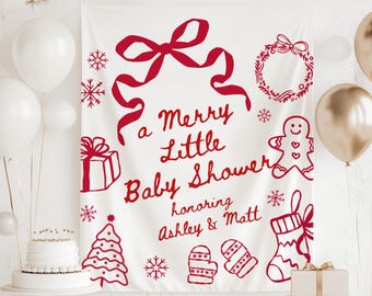 May include: A white banner featuring red festive illustrations and the text "a Merry Little Baby Shower" honouring Ashley & Matt. The design includes a bow, snowflakes, a gift, a wreath, a gingerbread man, a Christmas tree, mittens, and a stocking.