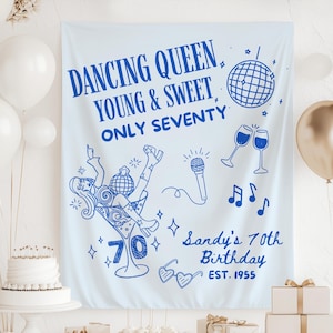 May include: A light blue fabric banner featuring dark blue line art graphics including a disco ball, a microphone, two champagne glasses, musical notes, heart-shaped glasses, and a person in a martini glass with the text DANCING QUEEN YOUNG & SWEET ONLY SEVENTY Sandy's 70th Birthday EST. 1955.