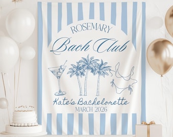 May include: A white banner with blue stripes and text that reads "Rosemary Bach Club" and "Kate's Bachelorette March 2026." The banner features illustrations of a martini, palm trees, and a bikini. White and gold balloons are in the background.