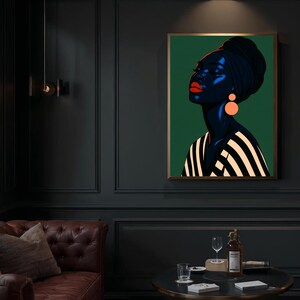 May include: A framed art print featuring a stylized portrait of a woman with dark skin, wearing a black head wrap and orange earrings. The woman's lips are red, and she is wearing a black and white striped top. The background is a solid green.